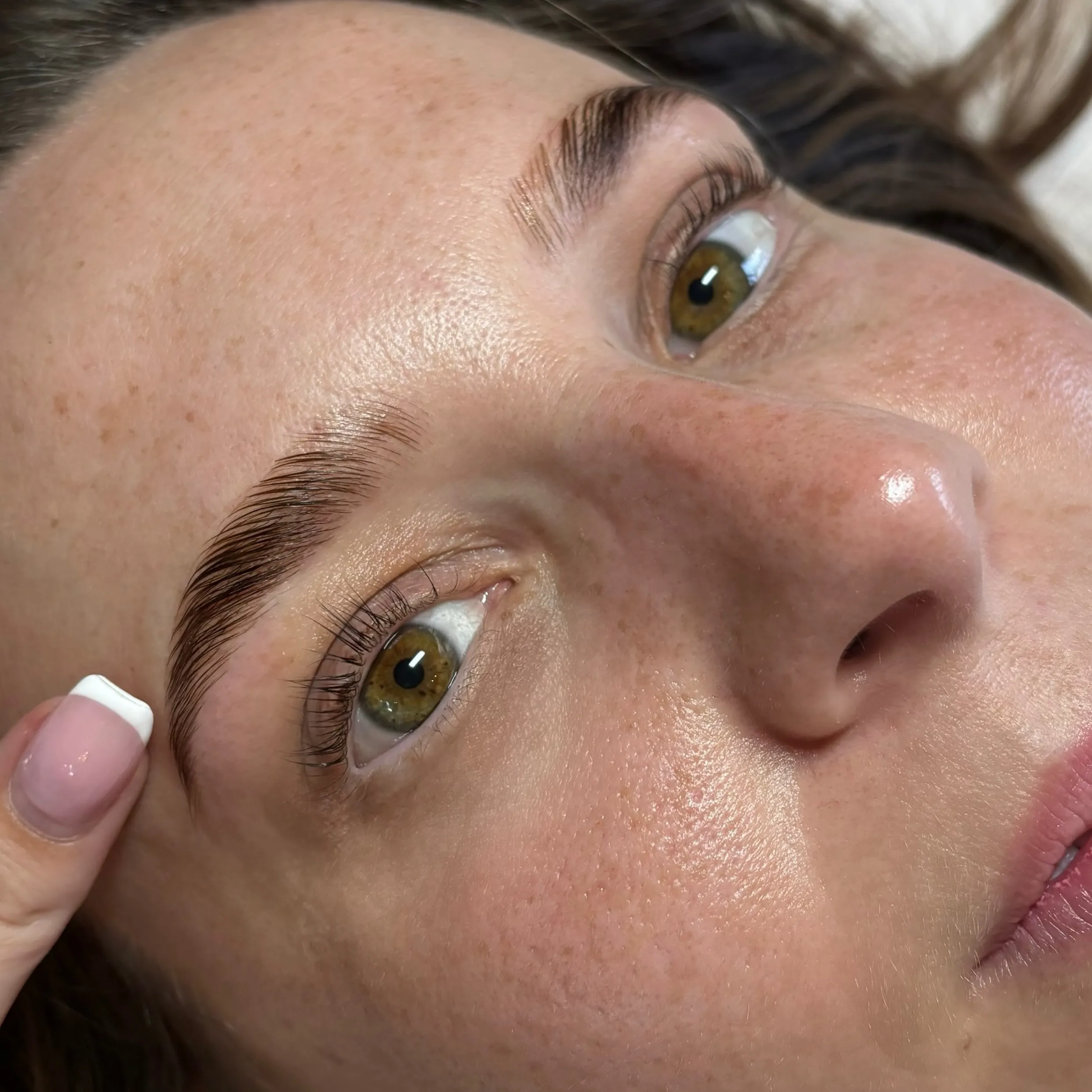A client in the studio after a lash lift and brow lamination
